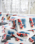  gift wrapped in christmas paper with santa in a red racecar