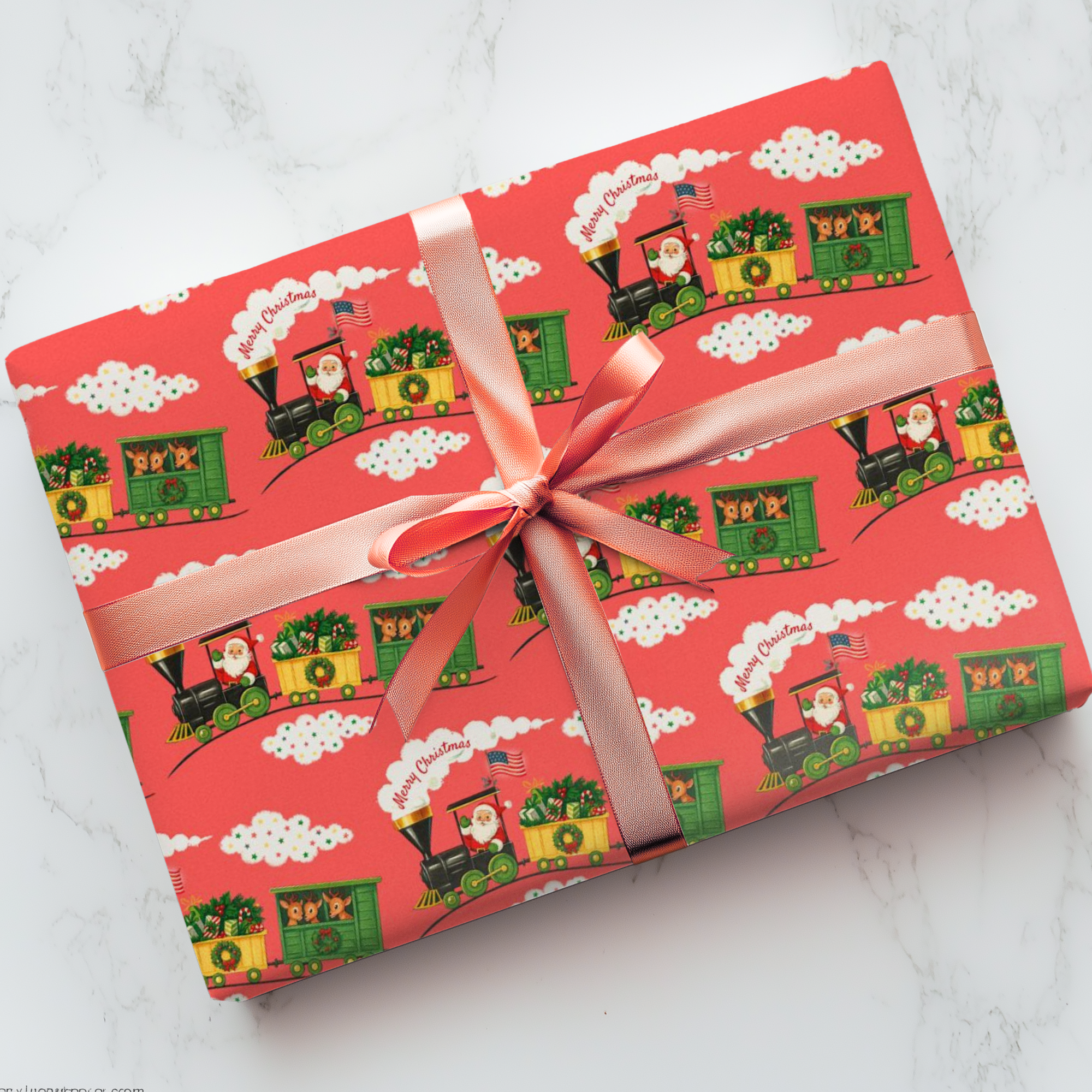 christmas wrapping paper featuring santa at the helm of a retro locomotive, america flag blowing in the wind, on a coral background.