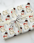 vintage golfing snowman Christmas wrapping paper with retro 1950s snowman in top hat and red scarf holding a golf club.