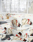 present wrapped in christmas themed paper featuring a snowman putting.