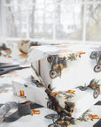 gifts wrapped in christmas wrapping paper that has a snowman driving a vintage model t 
