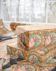 Gift wrapped in wrapping paper featuring pink rabbit in a gold frame pattern.