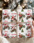 Christmas wrapping paper featuring Santa on a dirt bike doing tricks on a white background.