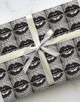 Surreal lips wrapping paper featuring a black and white repeating surrealist pattern from the Icona Obscura series.