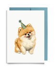 Greeting card with a Pomeranian dog wearing a party hat on a white background.