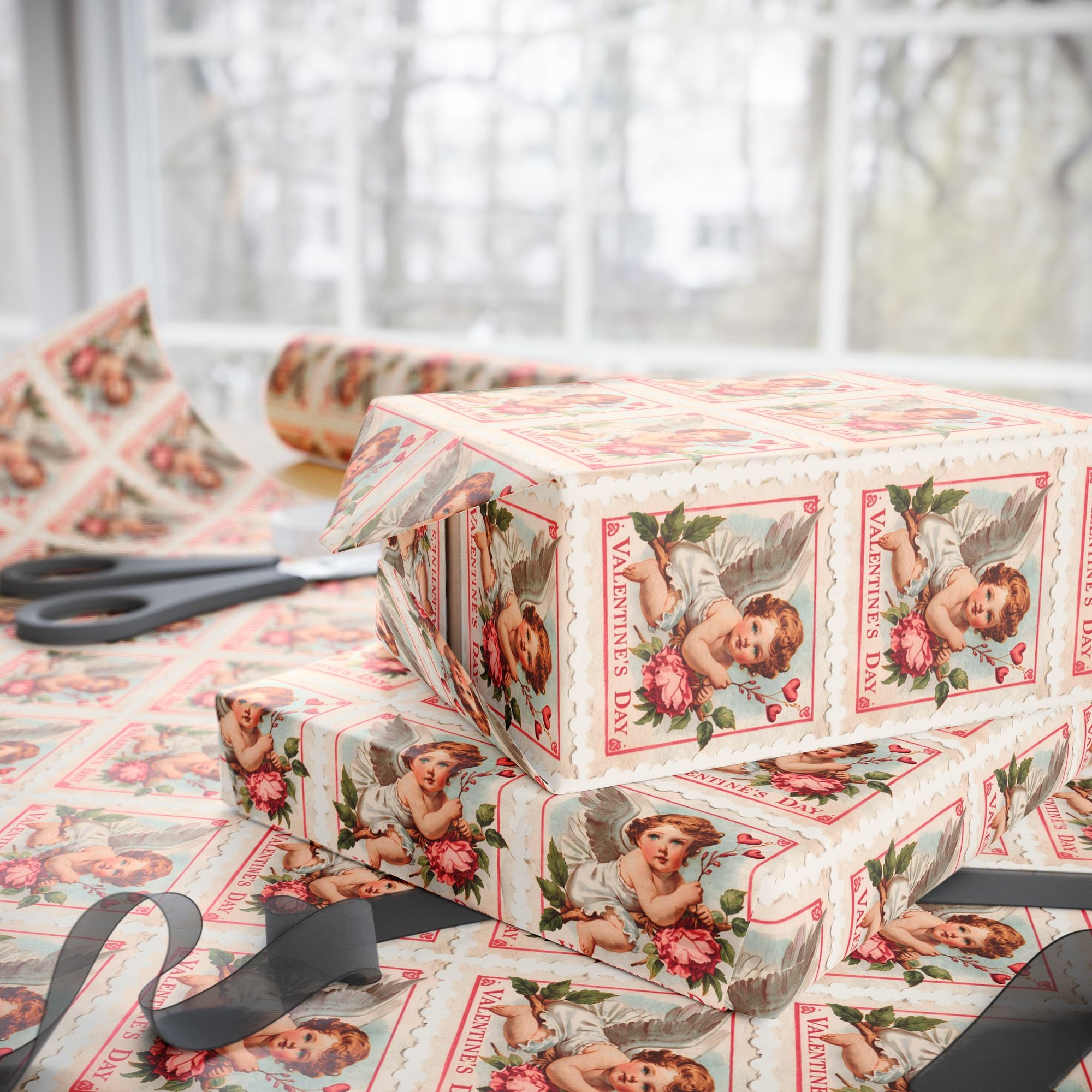 Boxes wrapped in vintage-style Valentine's Day postage stamp wrapping paper with cherubs and flowers on a table.