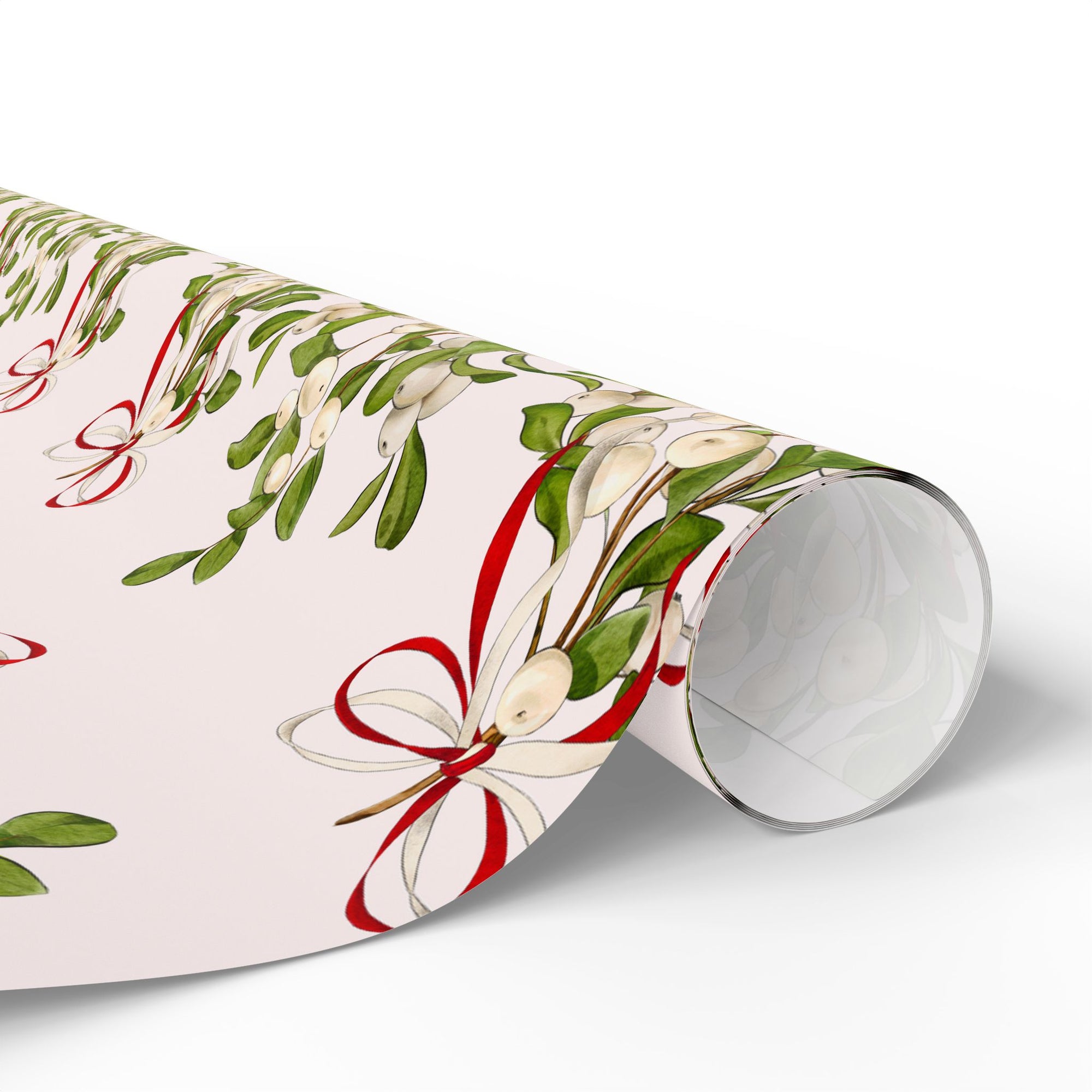 Vintage mistletoe wrapping paper with green leaves and red bows on blush background