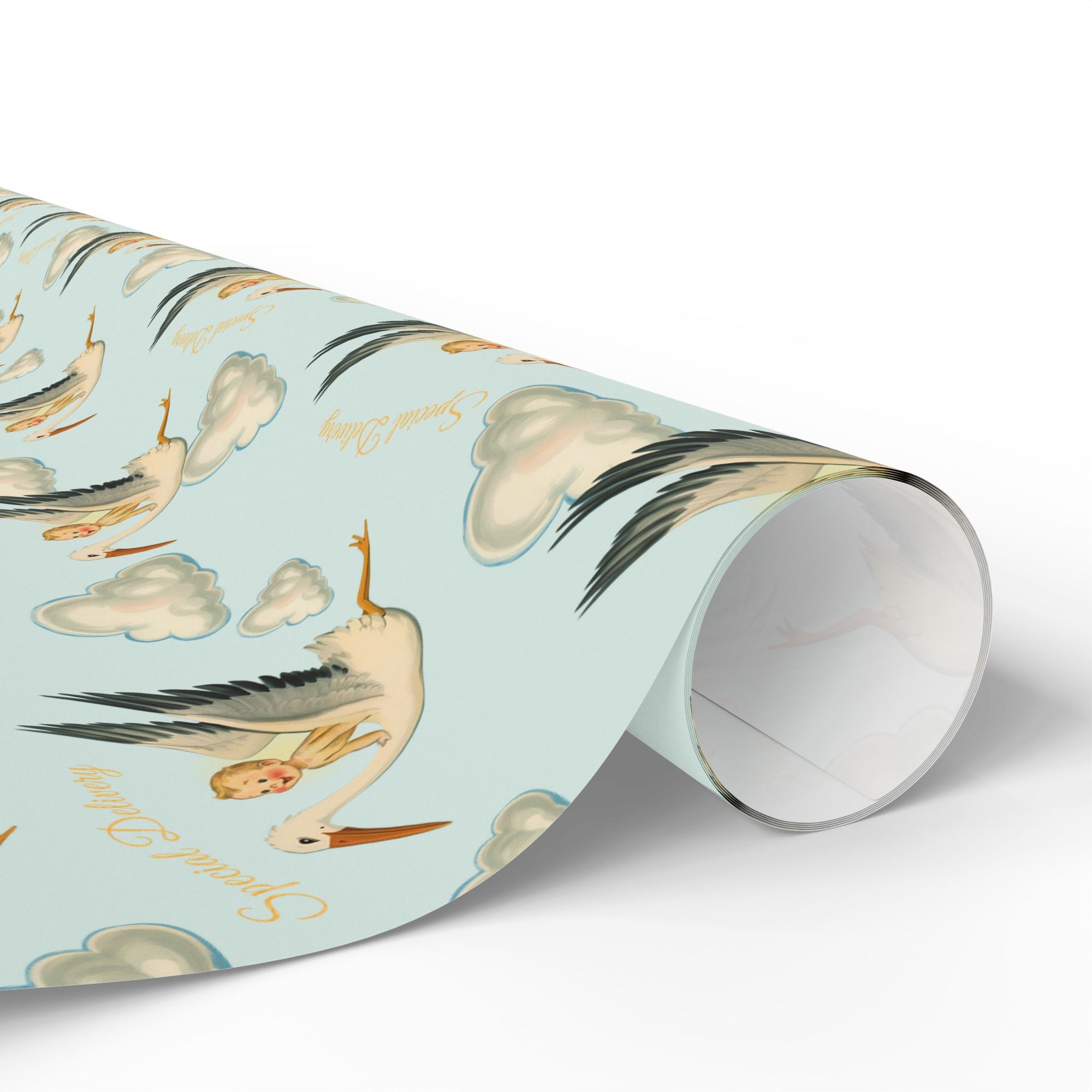 Roll of wrapping paper with stork, baby and cloud design on a light blue background