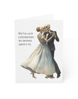 Skeletal couple dancing on a greeting card with text 'We've got chemistry. No bones about it.' on a white background.