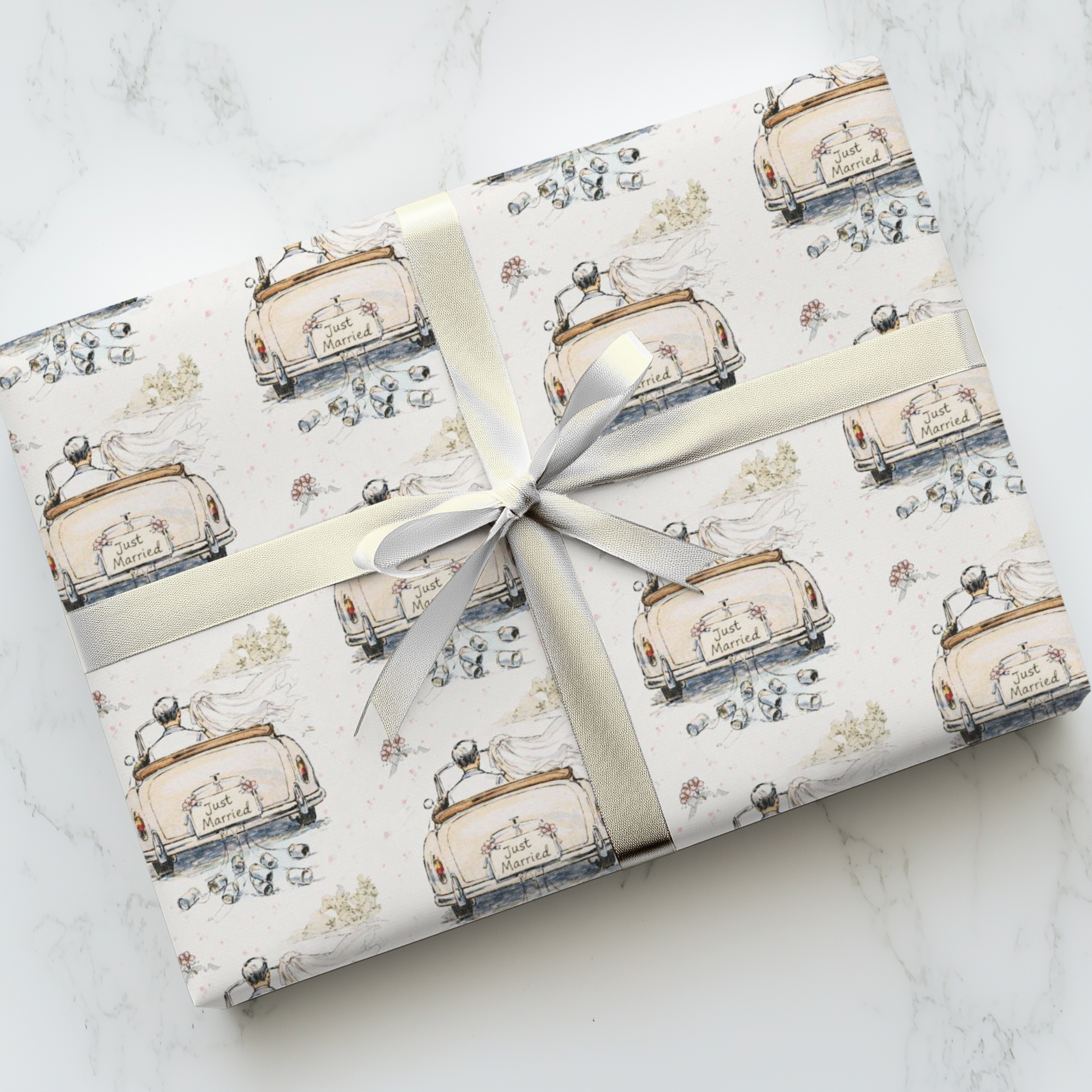 Romantic wedding gift wrap featuring vintage car with trailing cans on soft ivory background.
