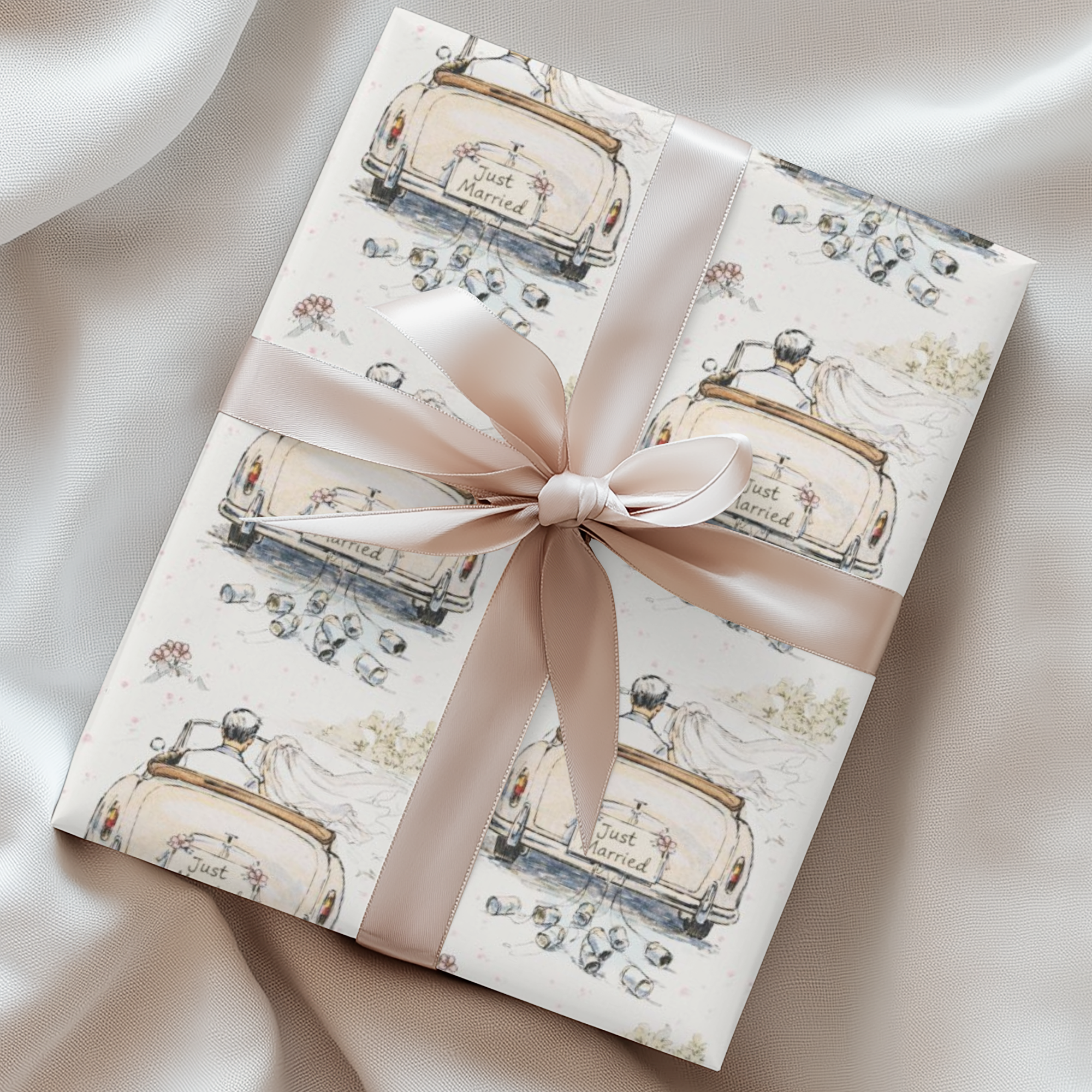 Wedding wrapping paper with just married car design in ivory and blush for bridal shower and newlywed gifts.