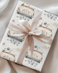 Watercolor wedding wrapping paper with a just married getaway car design in ivory and blush, featuring a vintage convertible and trailing cans for wedding shower and newlywed gifts.