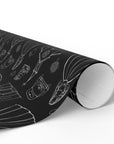 Roll of black and white wedding gift wrap on a white background.