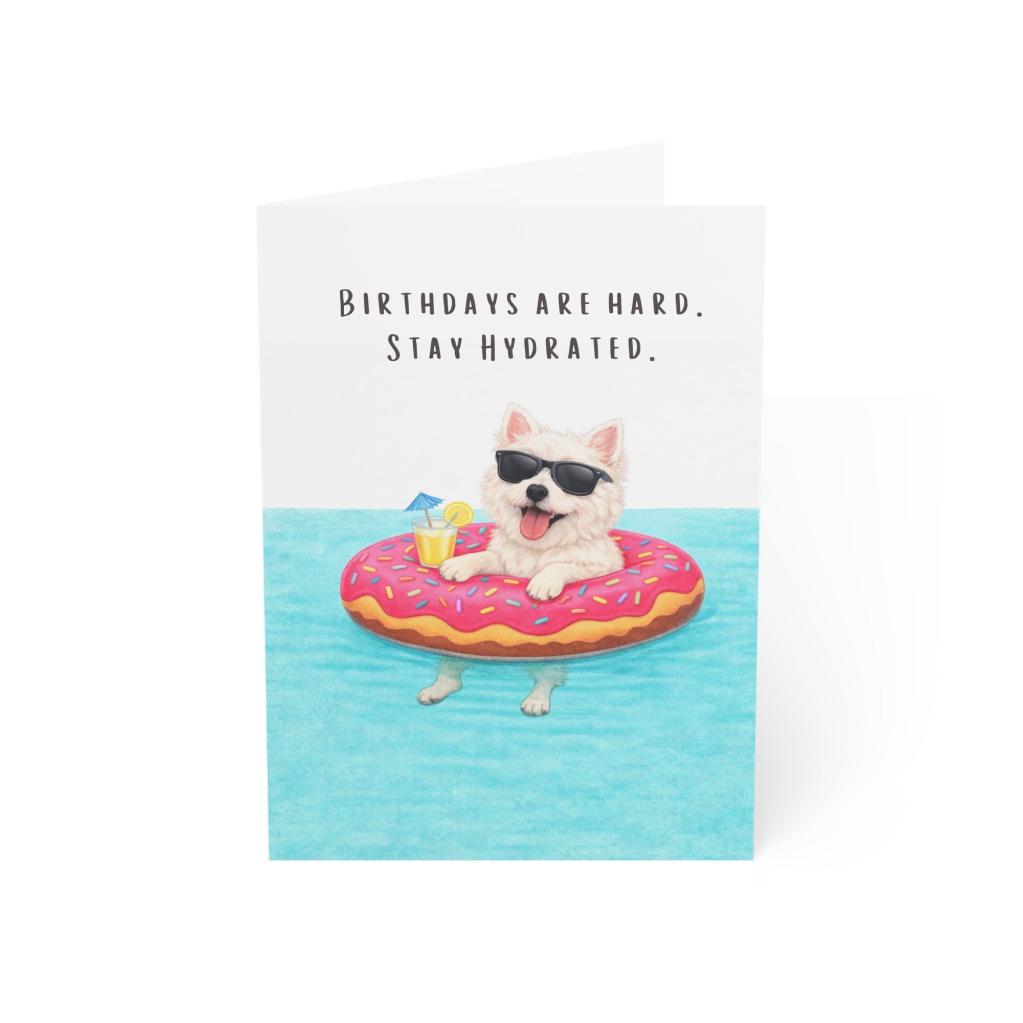Birthday card with a west highland terrier on a donut floatie and text 'Birthdays are hard. Stay Hydrated.'
