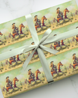 Gift wrapped in cowgirl-themed paper with a white ribbon on a marble surface