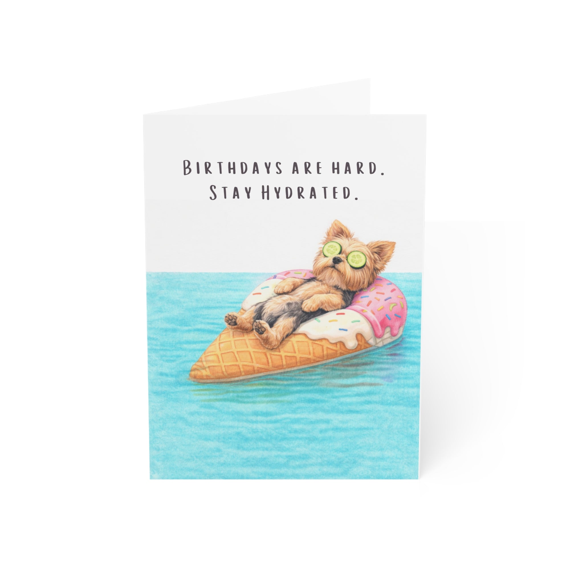 Card with a yorkie dog on an ice cream cone float and text 'Birthdays are hard. Stay Hydrated.' on a white background.